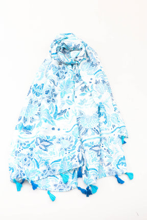 Blue and white floral patterned scarf with tassels on a white background