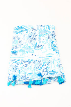 Blue and white floral patterned scarf with tassels on a white background