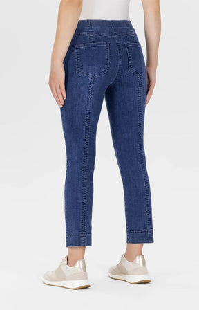 Person wearing blue jeans on a white background