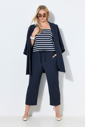 Woman wearing the Ulla Popken 7/8th Trousers in Navy with a striped top and navy blazer on a white background