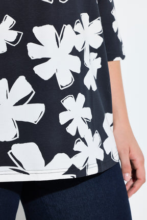 Ulla Popken Floral Keyhole Top in White, close up of navy top with white floral print with. 3/4 length sleeves