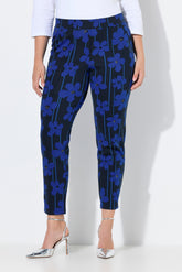 Women wearing the Ulla Popken Floral Trousers in Blue, a dark trousers with a blue floral design all over, has a tapered leg, side pocket 