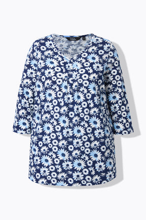 Product image of the Ulla Popken Flower Top in Blue, showing the dark blue shade with an all over white floral print, a rounded V neckline leading to decorative pleats, 3/4 length sleeves and a comfortable A-line shape 