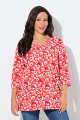 Woman wearing the Ulla Popken Flower Top in Red, a red floral top with a pleated V neckline, 3/4 length sleeves and an A-line shape against a white background