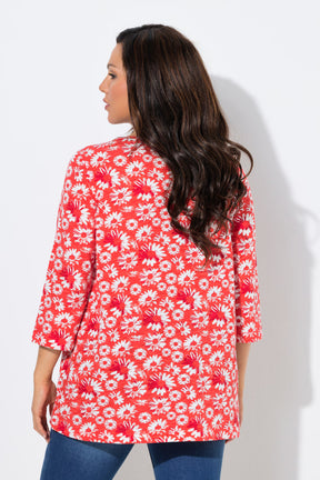 Woman wearing the Ulla Popken Flower Top in Red, a red floral top with a pleated V neckline, 3/4 length sleeves and an A-line shape against a white background