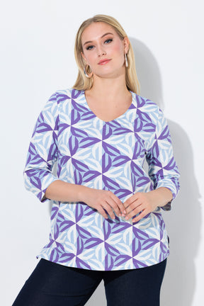 Woman wearing the Ulla Popken Geometric Top in Purple, a purple and blue patterned blouse against a plain background