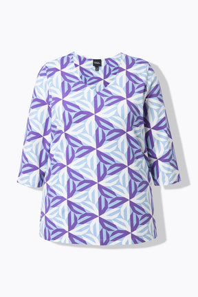 Product image of the Ulla Popken Geometric Top in Purple, a purple geometric patterned top with a V neckline, 3/4 length sleeves and an A-line shape against a white background 