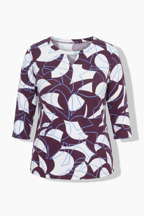 The Ulla Popken Keyhole Leaf Print Blouse in Wine, A women's three-quarter sleeve top with a keyhole neckline, featuring an abstract geometric pattern in wine, white, and light blue lines on a light gray background.