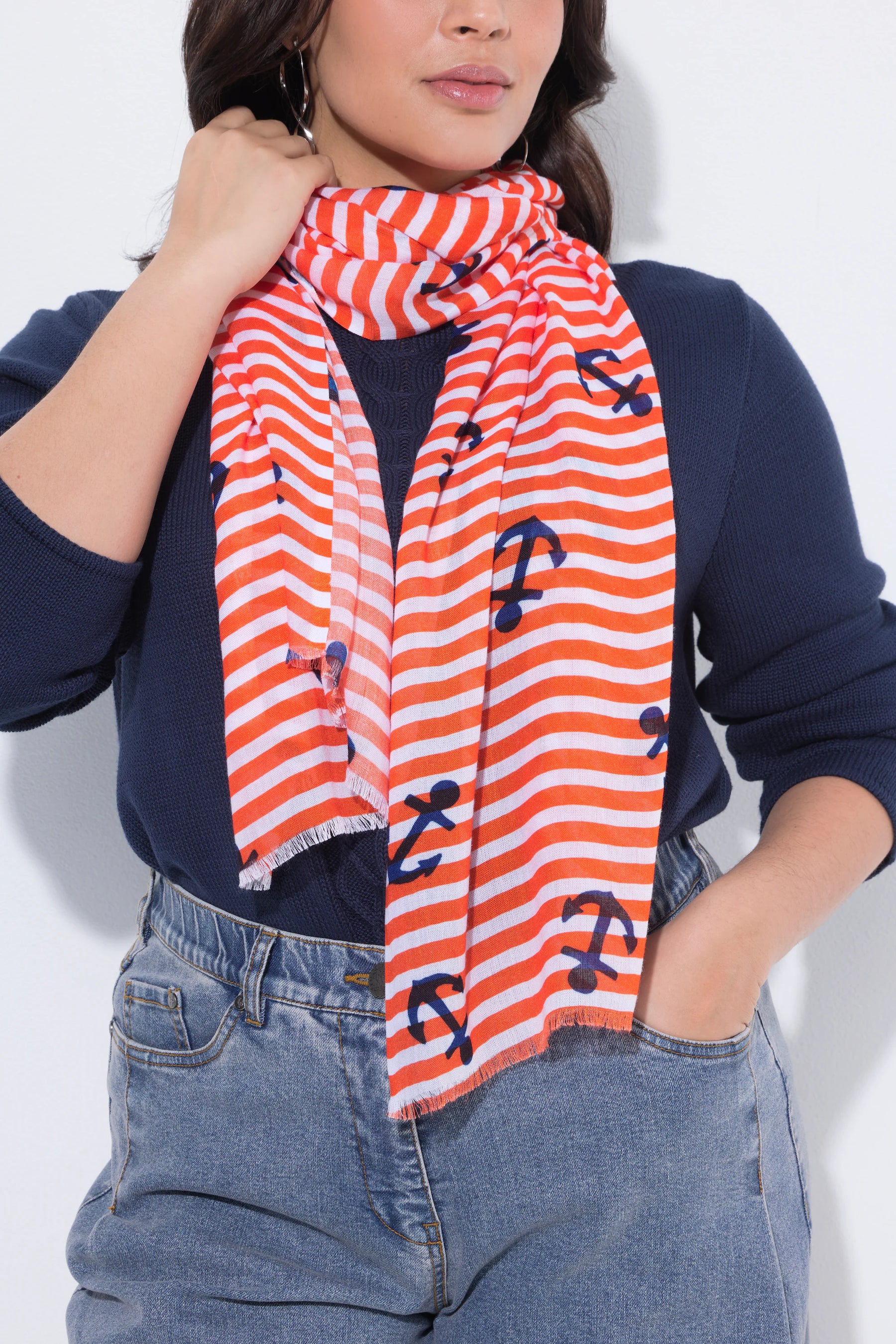 Women wearing the Ulla Popken Orange Anchor Scarf an orange and white striped scarf with anchor patterns on a plain background
