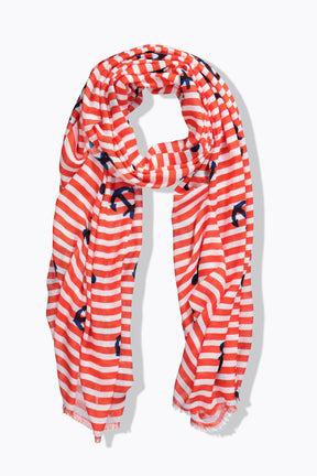 Orange and white striped scarf with blue anchor patterns on a white background