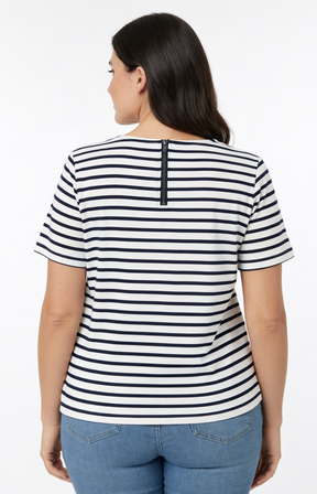 Woman wearing a black and white striped shirt with a plain background