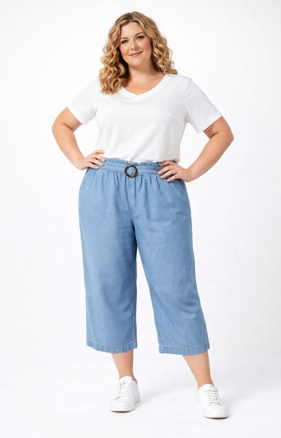 Woman wearing a white t-shirt and light blue denim pants on a white background