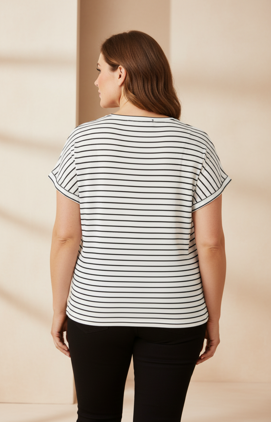 Woman wearing a striped shirt against a beige background
