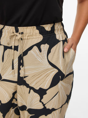 Beige and black patterned pants with a plain background