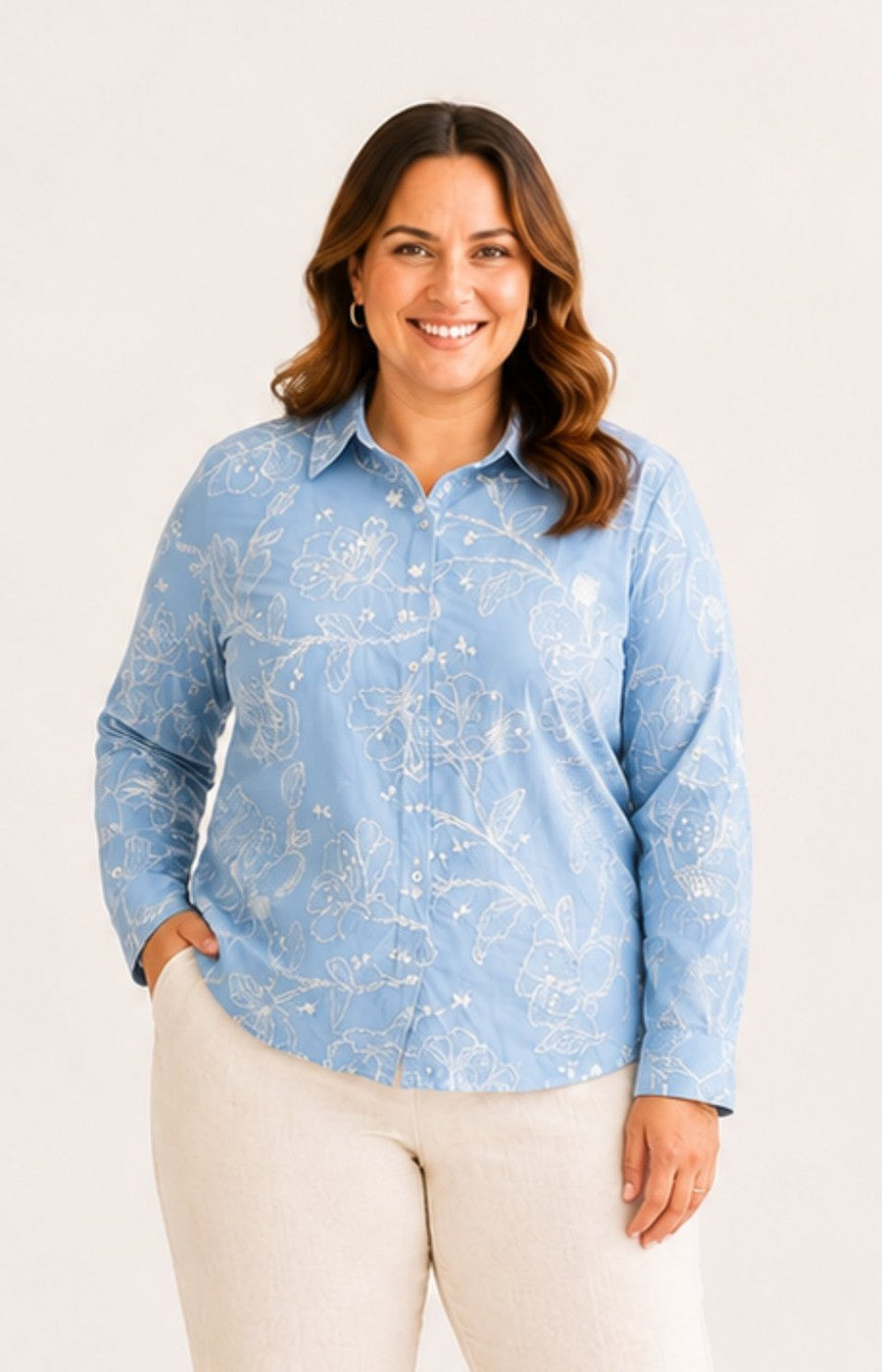 Woman wearing a blue patterned shirt against a white background