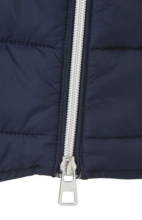 Close-up of a navy blue padded gilet with a silver zipper on a white background
