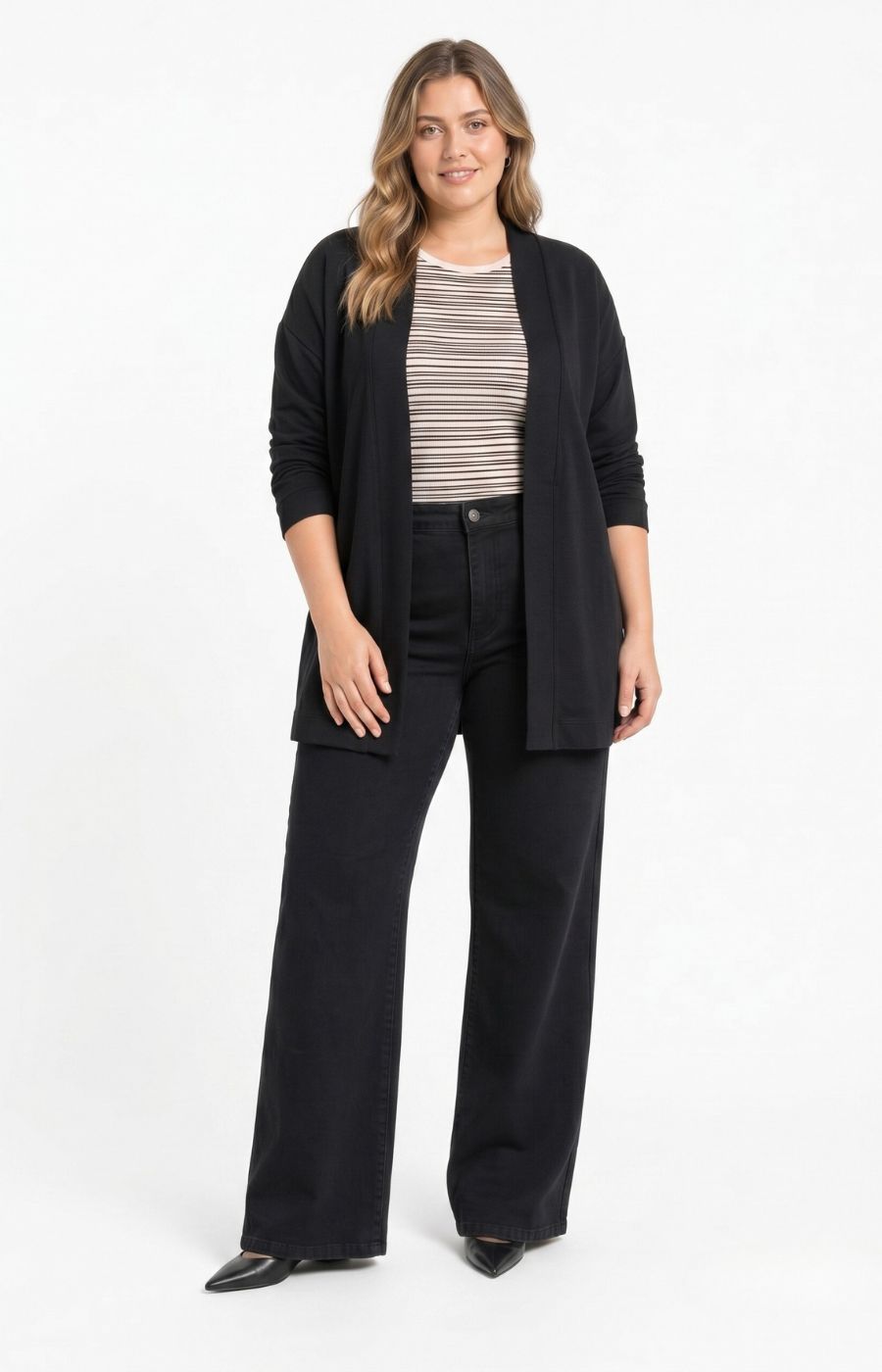 A woman modeling the Wasabi Sabina Pocket Cardigan in Black,  a black open-front cardigan over a beige and black striped top with black wide-leg pants, photographed against a plain white studio background. This image has been created using AI. 