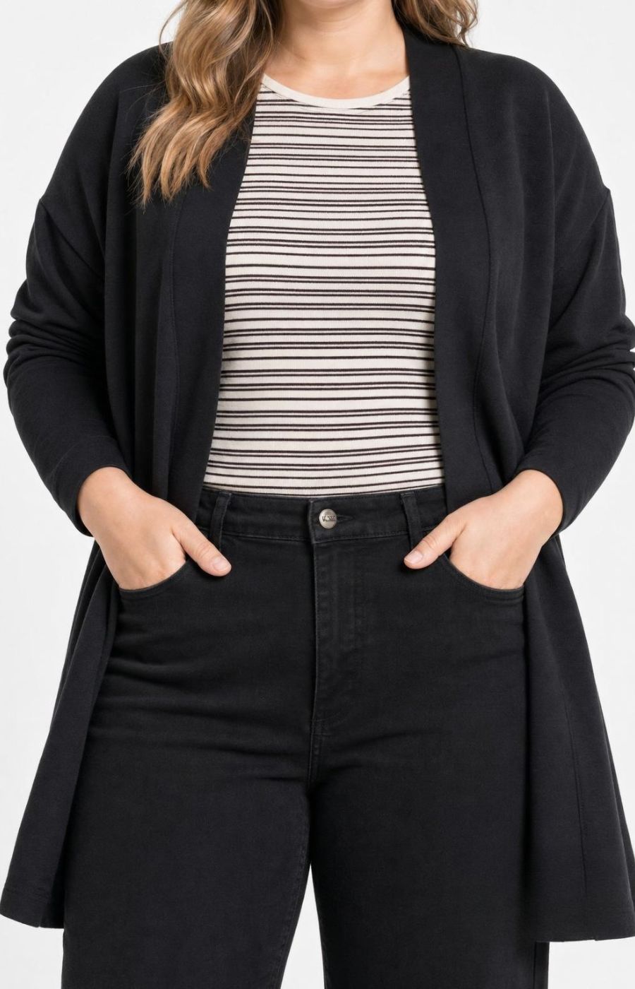 A woman wearing the Wasabi Sabina Pocket Cardigan in Black, a black open-front cardigan over a beige and black striped top with black jeans, shown from the shoulders to the upper thighs against a plain light background. This image has been created using AI.