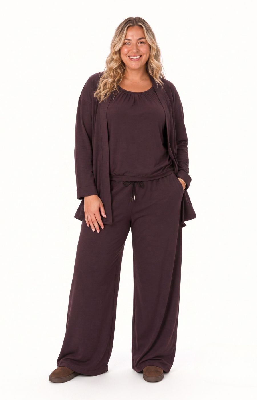 A woman modeling the Wasabi Sabina Pocket Cardigan in Brown, photographed against a solid white background. This image has been created using AI
