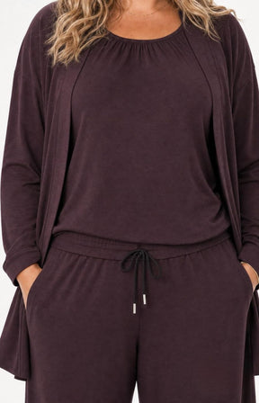 A woman wearing the Wasabi Sabina Pocket Cardigan in Brown. This image has been created using AI