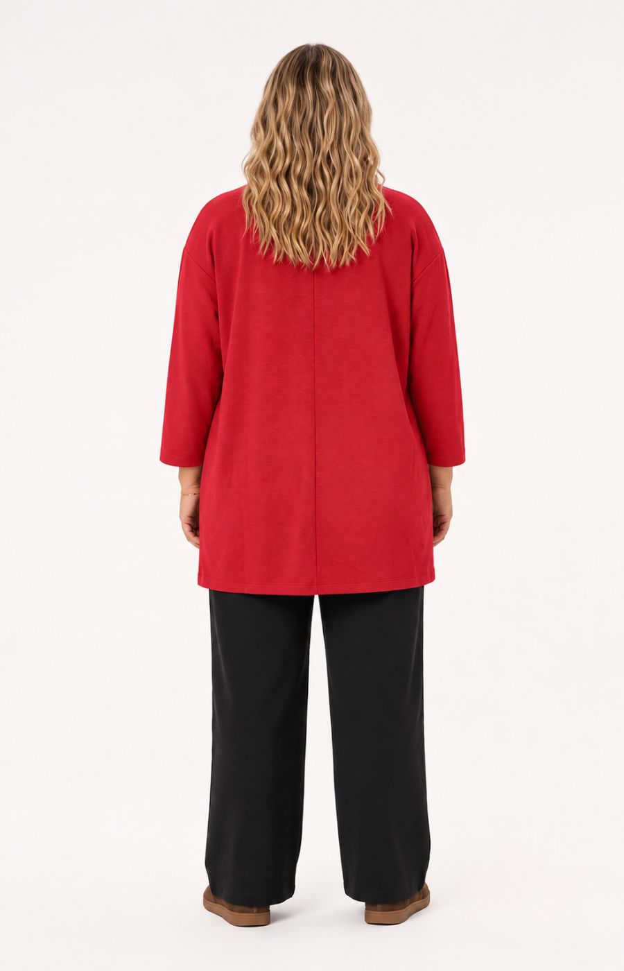 A woman viewed from the back wearing the Wasabi Sabina Pocket Cardigan in Red, a bright red long-sleeve tunic-style top and black wide-leg pants, standing against a plain light background. This image was created using Ai