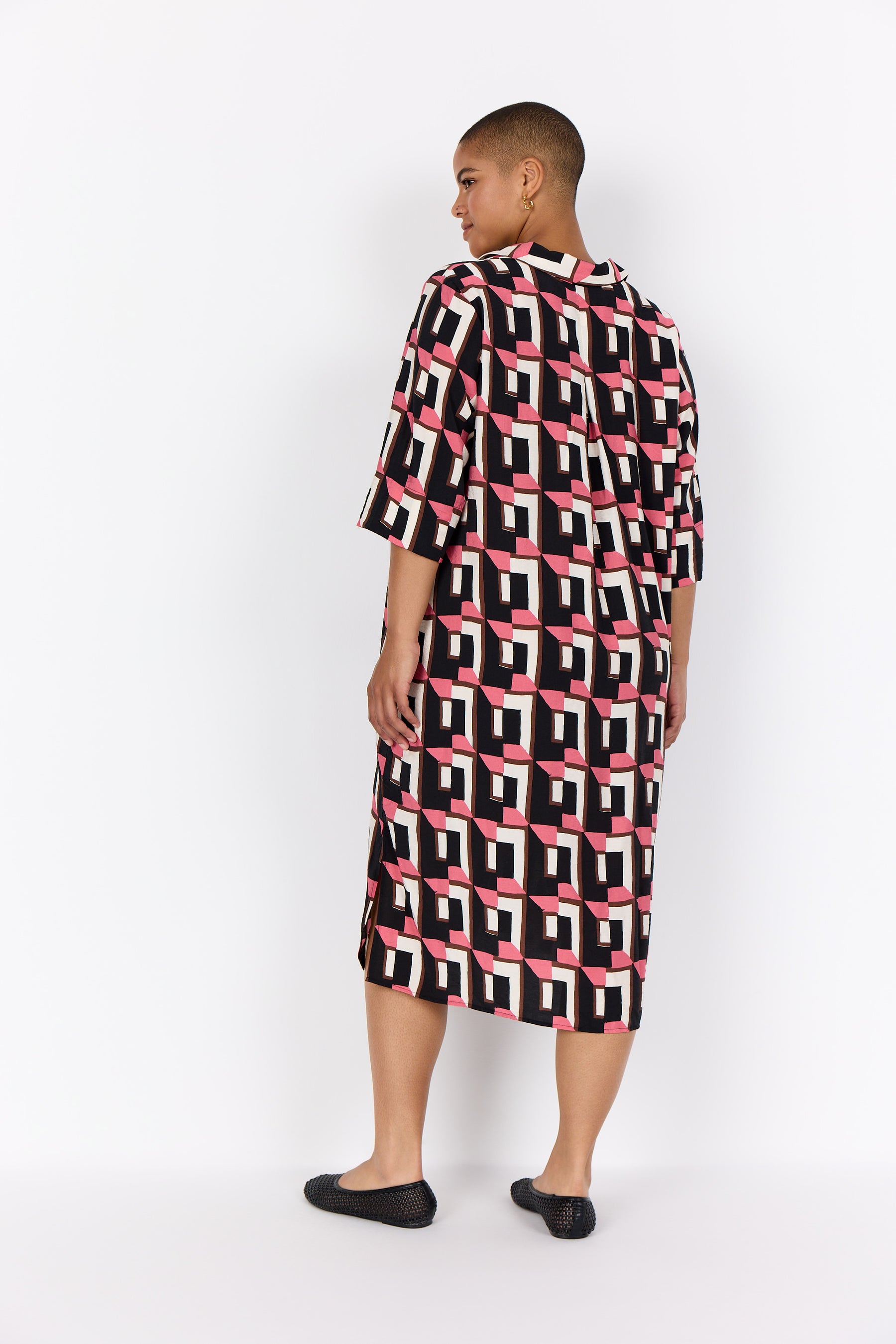 Person wearing Wasabi Sarena Dress in Pink with a white background, a midi length dress with 1/2 sleeves 