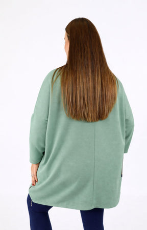Person wearing a Zara Sweater in Sage on a white background