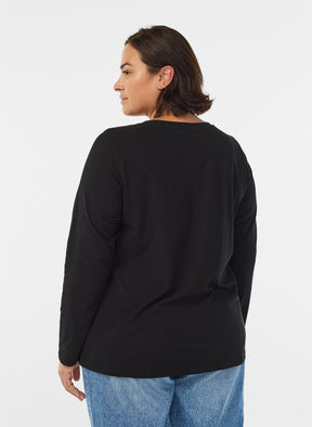 A woman shown from the back wearing the Zizzi Long Sleeve Top in Black, a black long-sleeve top and blue jeans against a plain light gray studio background.