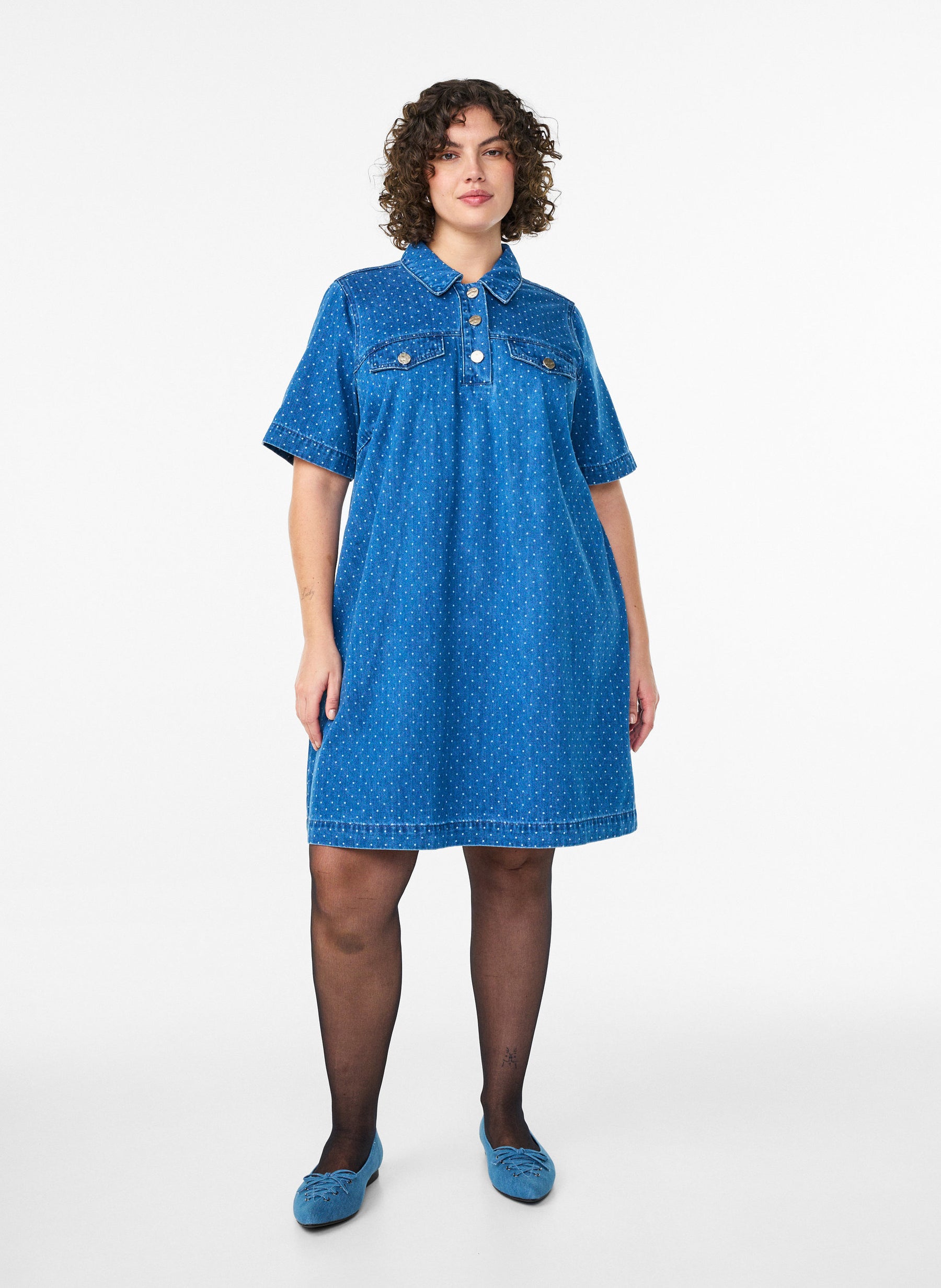 Woman wearing the Zizzi Misha Denim Dress, a blue dress with a white background