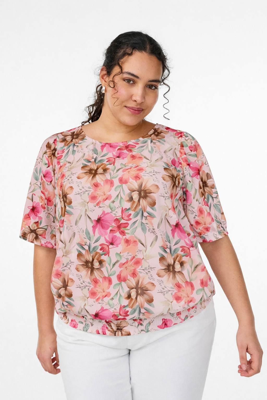 Women Wearing printed floral blouse on a white back ground.