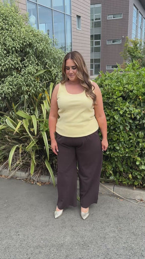 Modal is wearing the Only Carmakoma Stilla Trouser in Black Coffee with the Kaffe Curve Carina Vest in Sunlight